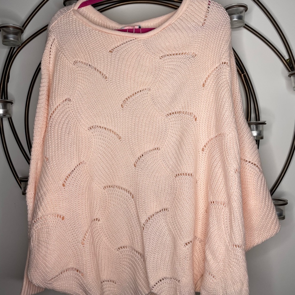 Blush pink woman’s oversized sweater.